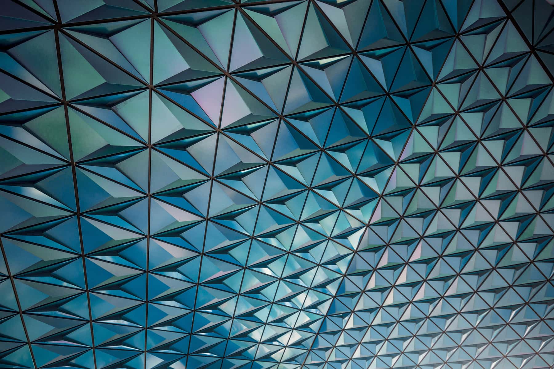 abstract-architecture-triangle-design Concrete beams create triangle pattern on glass ceiling allowing light into staircase